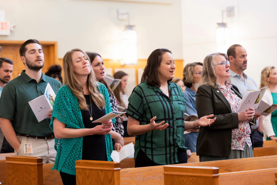 Faculty and staff worshipping together