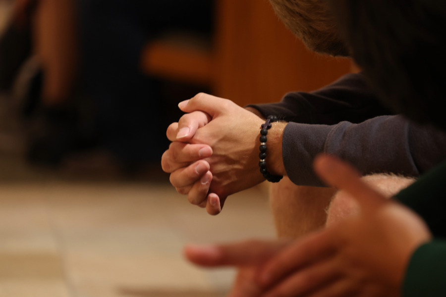Close up of hands folded in prayer