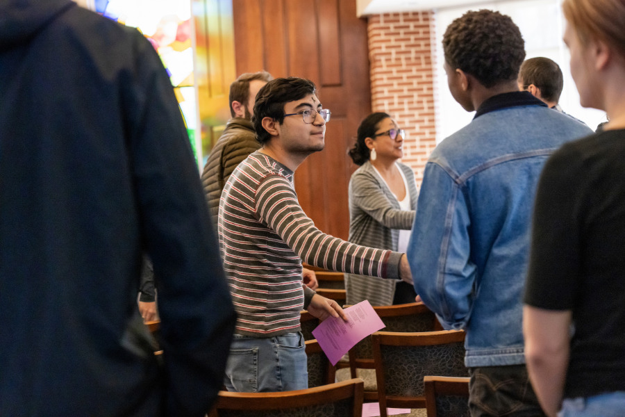 Graduate students shaking hands in a church