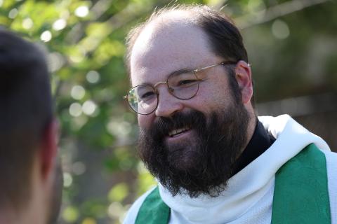 Rev. Matthew Aughtry speaking to a student